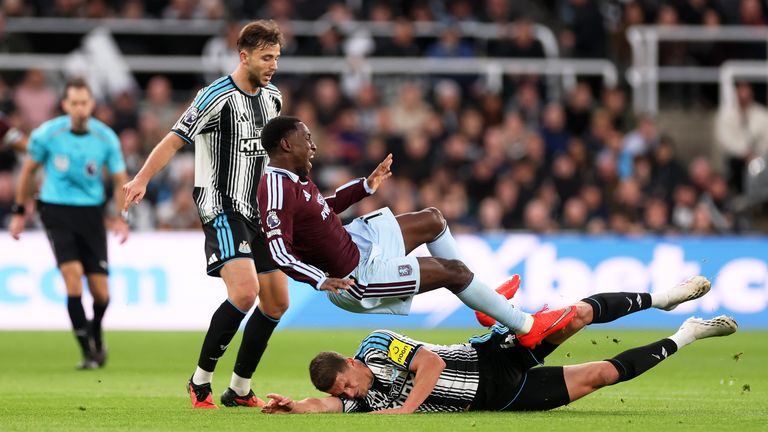 Aston Villa striker Nicolas Jackson is fouled by Newcastle defender Sven Botman